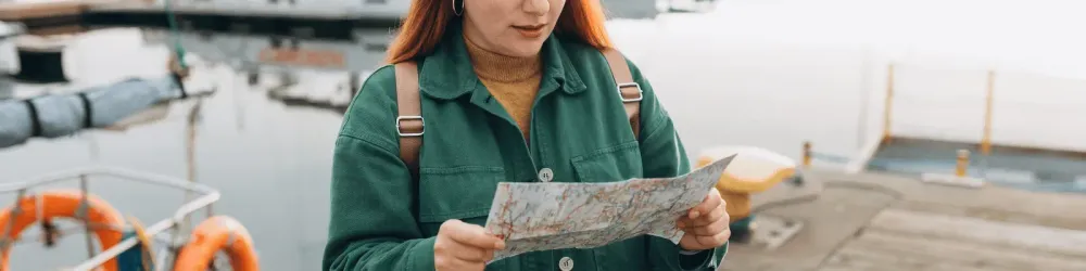 Confused traveler looking at city map
